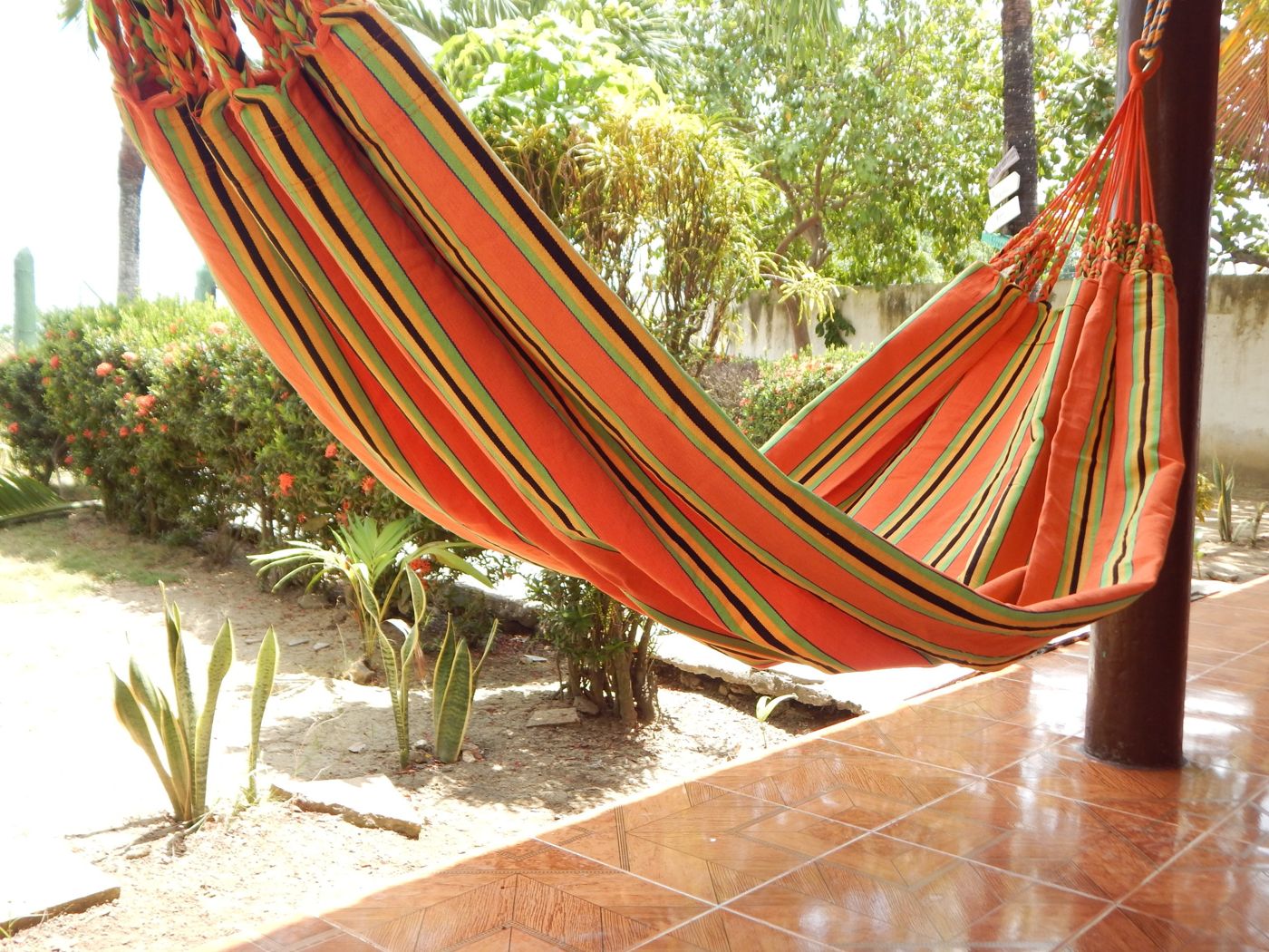 Hamaca naranja junto al jardín